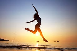 girl jumping beach shutterstock_96648499-2 small